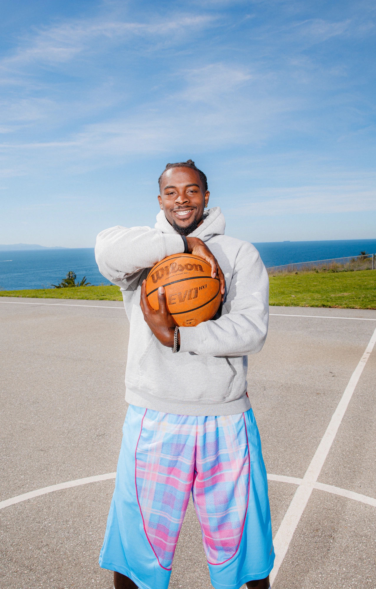 DK holding the ball to his chest, ocean behind