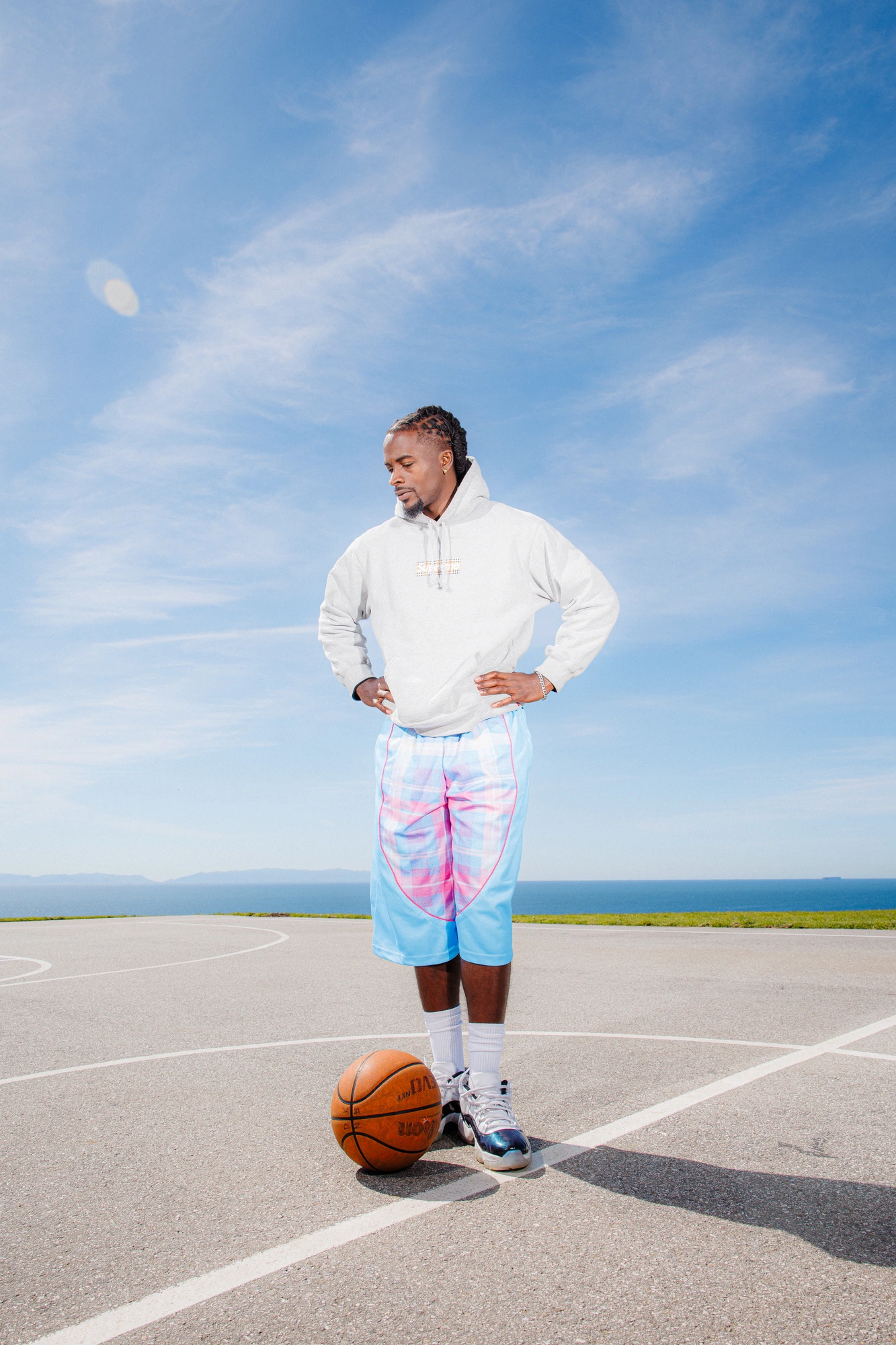DK standing, hands at his waist, ball at his feet