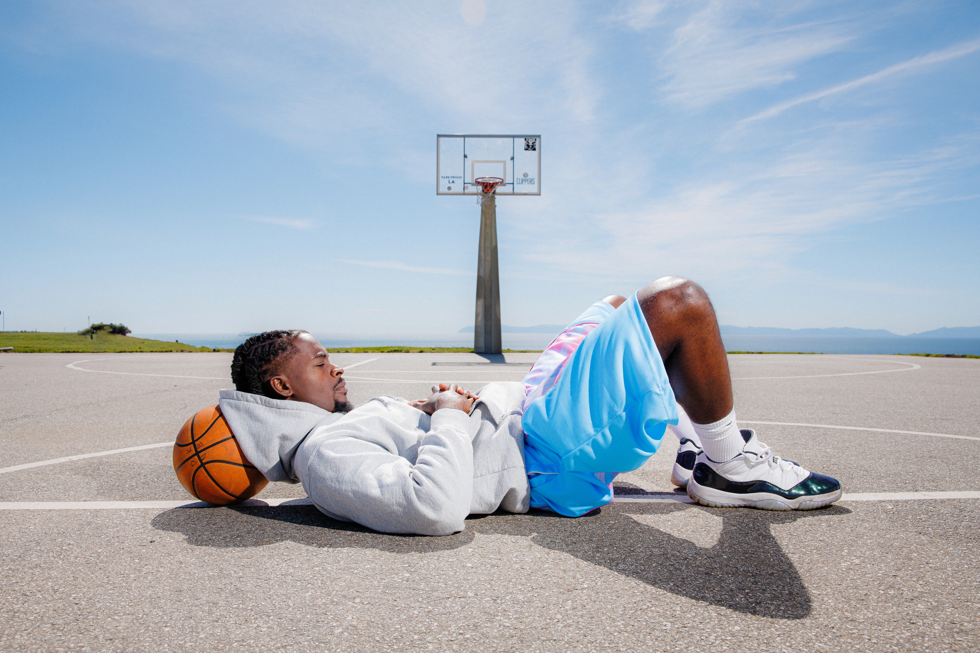 DK lying back on the court under the hoop