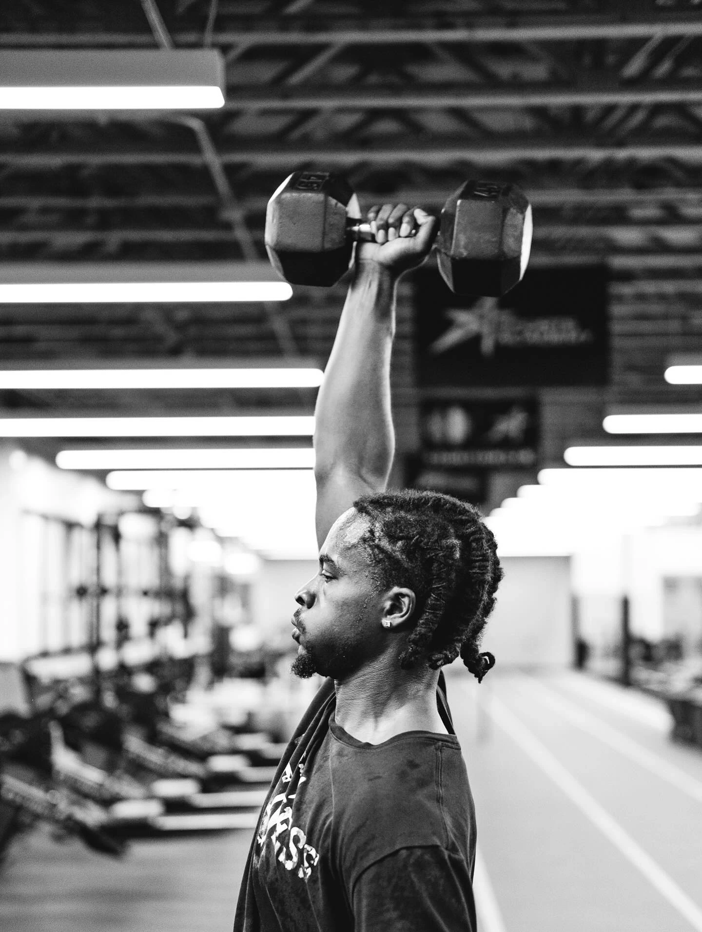 DK pressing a dumbbell overhead