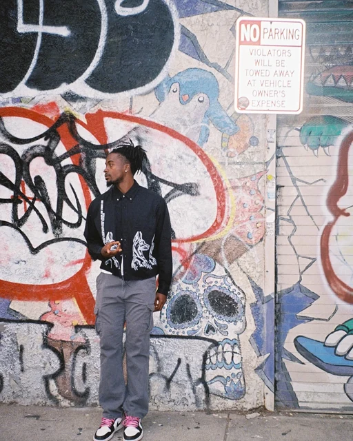 DK against a graffitied wall