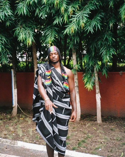 DK in a wrapped textile against palms